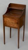 A 19th century mahogany bedside cupboard
The galleried back with a shaped shelf above the single