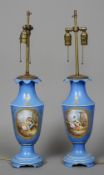 A pair of Sevres style porcelain table lamps
Each on a blue ground painted with a figural vignette.