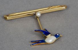 An Edwardian 15 ct gold and enamel pearl set drop brooch
Formed as a swallow, centrally set with a