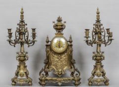 A 19th century Gothic Revival gilt brass cased clock garniture
The clock with floral urn surmounts