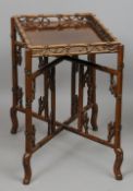 A Chinese carved hardwood folding tray top table
Of faux bamboo design.  66 cm wide. CONDITION