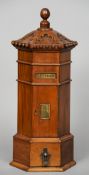 A carved wooden post box form visiting card holder
Modelled as a Victorian pillar box.  55 cm