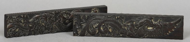 A pair of Chinese carved hardwood scroll weights
One worked with a phoenix, the other with a dragon.
