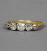 An 18 ct gold and diamond five stone ring CONDITION REPORTS: Stone flawing slightly yellow, some