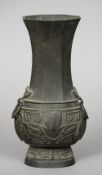 An archaistic style Chinese bronze vase The slender flared octagonal neck with twin loop and mask