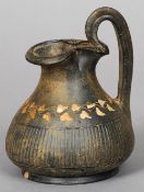 A Roman pottery ewer
Decorated with a band of floral motifs.  16 cm high. CONDITION REPORTS: Glaze