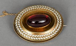 A Victorian enamelled and garnet set gold brooch
The verso with vacant glazed panel.  4 cm wide.