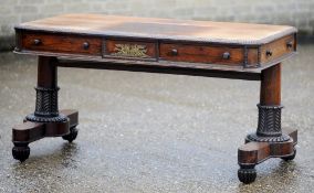 A Regency rosewood library table
The gadrooned rounded rectangular top above drawers and dummy