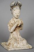 A Chinese Han pottery model of a musician
Formed as a kneeling woman playing symbols.  32.5 cm high.