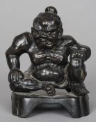 A 19th century Japanese patinated bronze model of a Sumo
Modelled seated.  15.5 cm high. CONDITION