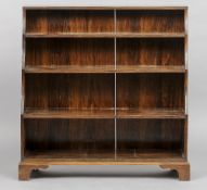 An early 20th century mahogany waterfall bookcase
The reeded curved uprights supporting four