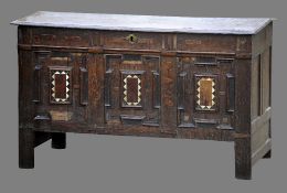 An 18th century oak coffer
The moulded rectangular top above the geometrically moulded amboyna,