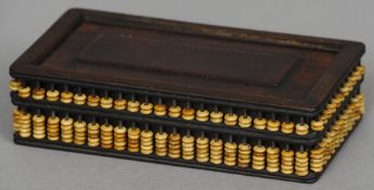 A Chinese hardwood box
The sides mounted with abacus beads.  20 cm wide. CONDITION REPORTS: