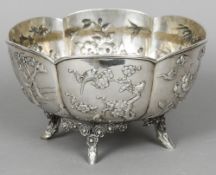 A 19th century Chinese silver bowl Of lobed form, decorated in relief with panels of various