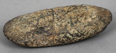 An early, possibly Stone Age, axe head
Of typical form.  10 cm wide. CONDITION REPORTS: Some