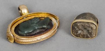 Two unmarked gold mounted fob seals
One of revolving form carved with a classical figure.  The