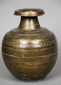 An antique Eastern bronze storage jar
With flared rim, ring turned decoration and ancient script.