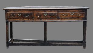 An 18th century oak dresser base
The moulded rectangular top above three frieze drawers, standing on