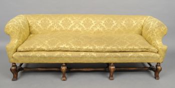 A Victorian walnut framed settee
The padded arms and back above the cushioned and padded seat,