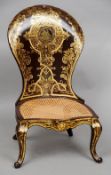 A Victorian papier mache spoon back nursing chair
The shaped back with gilt and mother-of-pearl