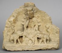An antique Chinese stone fragment 
Carved with the figure of Guanyin flanked with a pair of temple