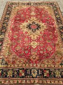 A Tabriz wool carpet
The wine red field enclosing a central medallion with stylised pendant