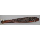 A tribal hardwood hand club One side with carved decoration. 39 cm long. CONDITION REPORTS: Some
