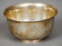 A small late 19th/early 20th century Chinese silver bowl
Decorated in the round with blossoming