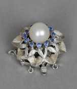 A 14 ct white gold, pearl and stone set clip
Set as a flowerhead.  2 cm diameter. CONDITION REPORTS: