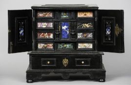 An Italian hardstone inset ebonised table cabinet
The twin panelled doors enclosing an arrangement