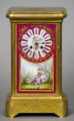 A 19th century Continental Sevres style painted porcelain panel mounted mantel clock
The dial with