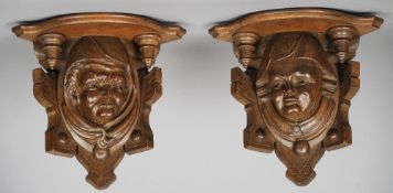A pair of late 19th century Continental wall brackets
Each centred with a figural mask.  Each 25