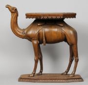A 19th century carved hardwood side table
The florally carved octagonal top above the camel form