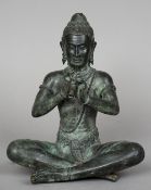 An antique Eastern bronze figure of Buddha Modelled seated cross legged playing a flute. 29 cm high.