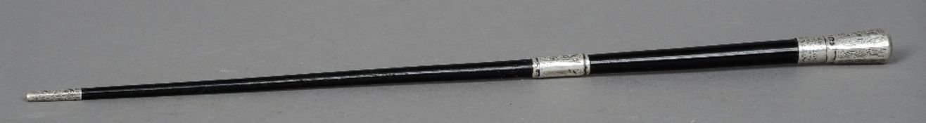 An early 20th century silver mounted ebonised swagger stick, hallmarked London 1915, maker's mark