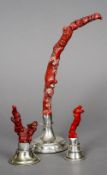 Three white metal mounted red coral specimens
The largest 31 cm high.