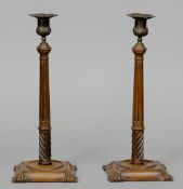 A pair of early 20th century brass mounted walnut candlesticks
Each 36.5 cm high.  (2) CONDITION