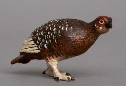 A small cold painted model of a grouse
Naturalistically modelled.  9 cm long. CONDITION REPORTS: