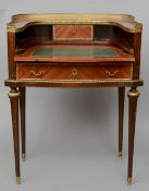 A 19th century style French bonheur du jour
The brass galleried top above the sliding leather
