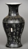 A Chinese brown glazed baluster vase
Decorated in the round with calligraphy and with a painted seal
