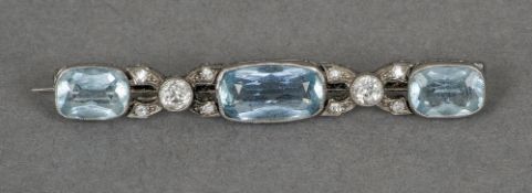 An unmarked white gold or platinum aquamarine and diamond bar brooch
The three canted rectangular