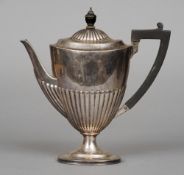 A Victorian silver coffee pot, hallmarked London 1893, makers mark indistinct
Of stopped gadrooned