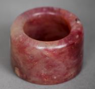 A Chinese russet jade archers ring
Of typical form. 3.25 cm diameter. CONDITION REPORTS: Overall