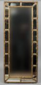 A 19th century giltwood and composition wall glass
The reeded frame with flowerhead and leaf motifs.