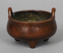 A small Chinese patinated bronze censer Of typical squat form, with twin loop handles, the underside