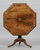 A Regency brass inlaid rosewood tripod table
The octagonal top with brass stringing centred with a