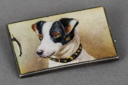 An unmarked silver and enamel brooch
Decorated with a Jack Russell.  3.25 cm wide. CONDITION