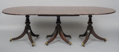 An 18th century style mahogany triple pillar dining table
The moulded D-end top above the turned