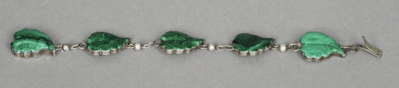 A white metal malachite set bracelet
Each link worked as a leaf.  22 cm long overall. CONDITION