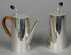 A pair of Christopher Dresser style silver coffee pots, one hallmarked Birmingham 1913, the other